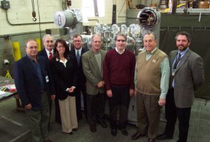  Left to Right: Joseph Rasson (Berkeley Lab), Bruce Strauss (DOE-Office of High Energy Physics), Eileen Cunningham (Meyer Tool), Jim Brosnahan (IL State Representative), Tom Peterson (Fermilab), Phil Pfund (Fermilab), Frank Meyer (President Meyer Tool) and Jim Kerby (Fermilab) stand in front of the first completed distribution box. 