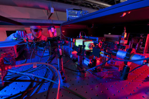 A Fermilab scientist works on the laser beams at the heart of the Holometer experiment. The Holometer will use twin laser interferometers to test whether the universe is a 2-D hologram. Credit: Fermilab.