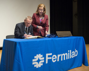 Fermilab Director Nigel Lockyer signs his name in the American Physical Society Register of Historic Sites while Laura Greene, vice president of the APS, looks on. Fermilab was officially designated an APS Historic Site in a ceremony on June 10, 2015 at the laboratory. Photo: Fermilab