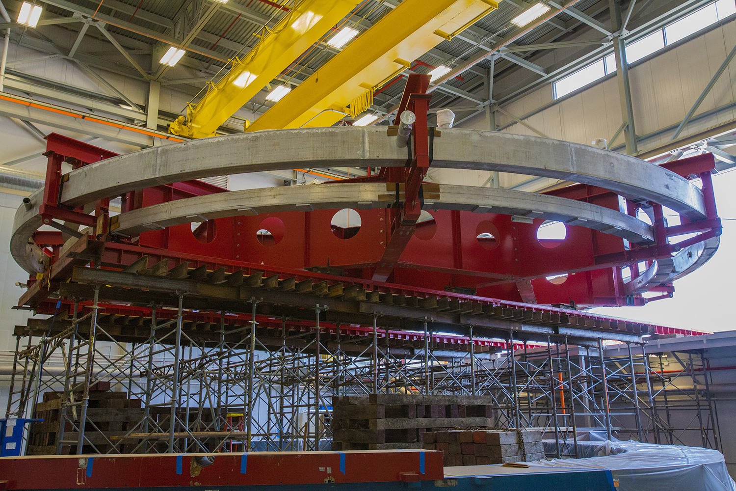 The 50-foot-wide Muon g-2 electromagnet at rest inside the Fermilab building that will house the experiment. The magnet was moved into the new building on Wednesday, July 30, 2014. The magnet will allow scientists to precisely probe the properties of subatomic particles called muons. Photo: Fermilab.
