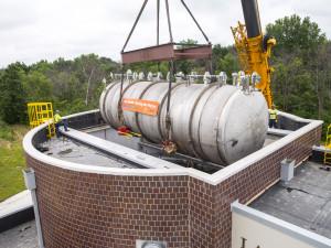 The 30-ton MicroBooNE neutrino detector is gently lowered into the Liquid-Argon Test Facility at Fermilab on Monday, June 23. The detector will become the centerpiece of the MicroBooNE experiment, which will study ghostly particles called neutrinos. Photo: Fermilab.