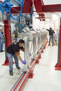 Members of the Fermilab Technical Division line up eight superconducting accelerator cavities to form a cavity string destined for SLAC National Accelerator Laboratory’s LCLS-II. Photo: Reidar Hahn