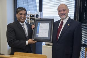 Fermilab Director Pier Oddone (right) accepts the ISO 20000 certificate from UL DQS CEO Ganesh Rao on Feb. 13 at Fermilab. Photo: Fermilab