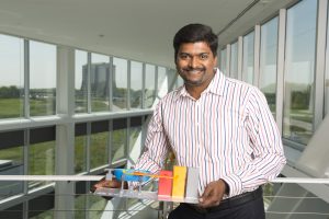Charles Thanagaraj holds a model of the compact accelerator he recently received a grant to develop. Photo: Reidar Hah