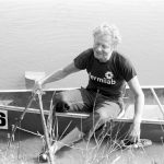Leon Lederman, Weary, wet and shoeless, a competitor climbs ashore at the 1979 finish line. Photo: Fermilab