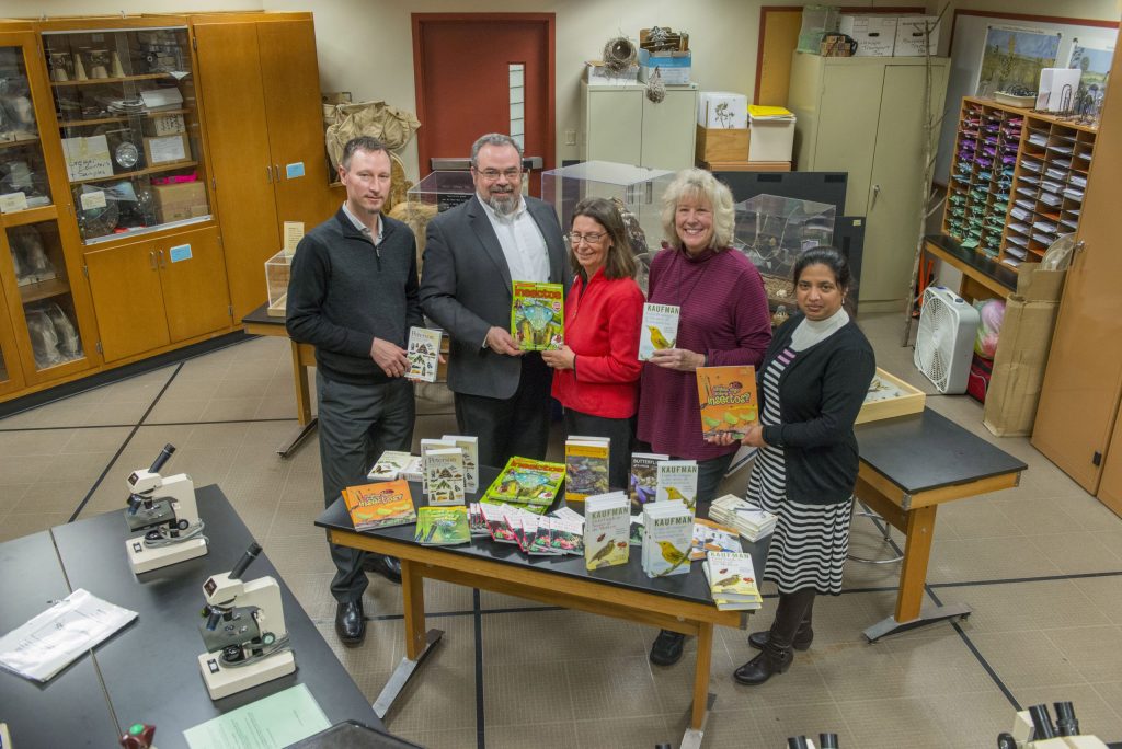 In the spirit of the season, the not-for-profit organization Fermilab Natural Areas presented the Lederman Science Center at Fermilab with an early gift. FNA, represented by President Penny Kasper (center) and Vice President Liz Copeland (second from right), donated a selection of environmental education books and field guides in English and Spanish to the center. The donation was made possible with a grant from the Nature Conservancy’s Volunteer Stewardship Network. Fermilab Chief Operating Officer Tim Meyer (left), Fermilab Office of Education and Public Outreach Manager Spencer Pasero and Fermilab Chief of Staff Hema Ramamoorthi received the gift on behalf of Fermilab. Photo: Fermilab