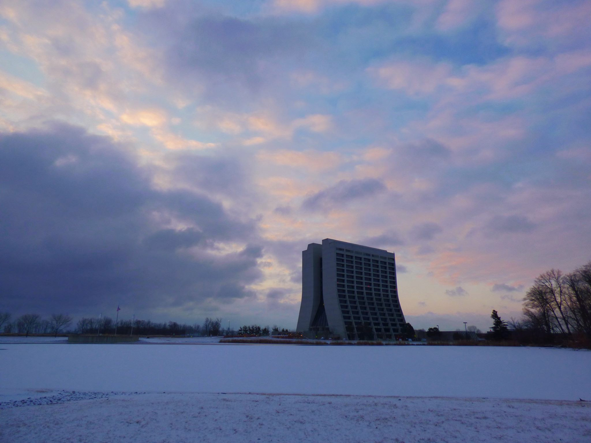 Wilson Hall and its surrounding scene is awash in light lavender light. Photo: Amy Scroggins, landscape, building, winter, snow, sky, cloud