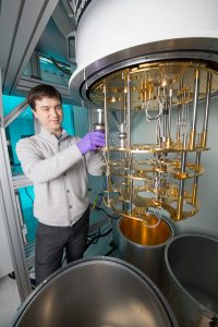 Alex Romanenko prepares to cool superconducting accelerator cavities, the silver-colored objects, to convert it into a quantum device. Photo: Reidar Hahn