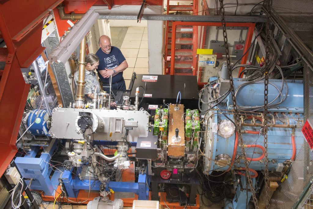 David Johnson, left, and Todd Johnson work on the recently installed laser notcher in the Fermilab accelerator complex. The laser notcher, the first application of its kind in an in-production particle accelerator, has helped boost particle beam production at the lab. Photo: Reidar Hahn