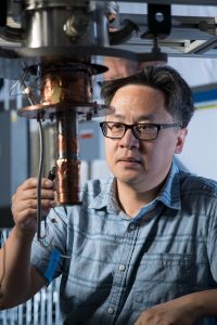 Aaron Chou works on an experiment that uses qubits to look for direct evidence of dark matter in the form of axions. Photo: Reidar Hahn