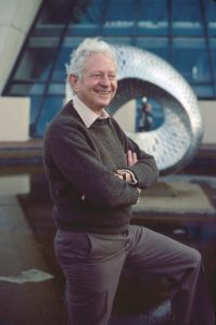 Leon Lederman stands outside Wilson Hall at Fermilab on the day he learned he was awarded the 1988 Nobel Prize.