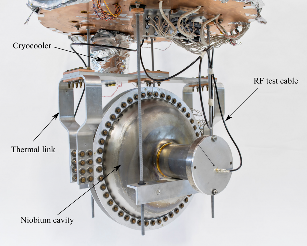 A superconducting radio-frequency accelerator cavity is mounted and connected to a cryocooler, cooling the cavity without the use of liquid helium. This new device could make it easier to produce high-average-power electron beams for industrial applications. Photo: Marty Murphy