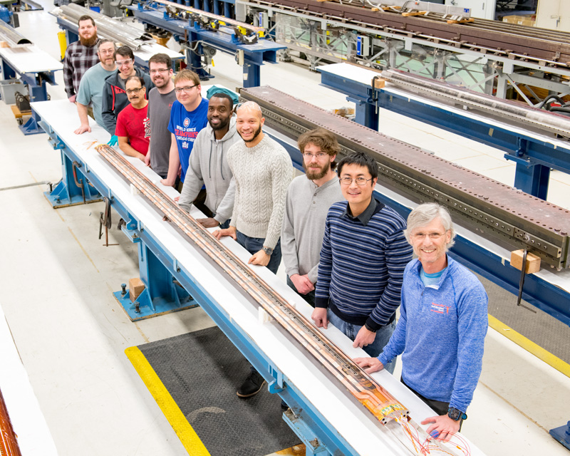Fermilab engineers and technicians stand by a magnet coil made for the High-Luminosity LHC. Photo: Reidar Hahn