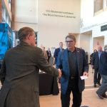 Fermilab's Tom Kroc, left, welcomes U.S. Energy Secretary Rick Perry to the Fermilab booth. Photo: Aaron Sauers