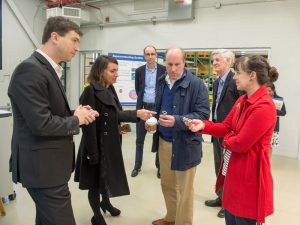 Alex Romanenko (from left) and Anna Grassellino talk to Under Secretary Paul Dabbar and his Chief of Staff, Kristin Ellis, about the potential applications of superconducting devices in quantum computing.