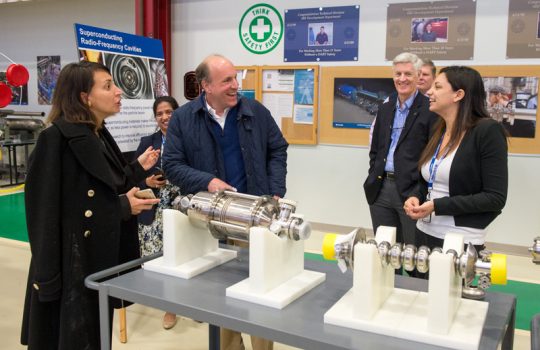 Martina Martinello (right) explains to DOE Under Secretary for Science Paul Dabbar (second from left) the importance of superconducting RF technology in building the next generation of particle accelerators. Looking on are, from left, Anna Grassellino, Hema Ramamoorthi, Chris Mossey and Mike Weis.