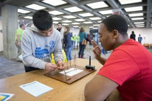 How do circuits work? This student is learning from another. Photo: Jim Shultz