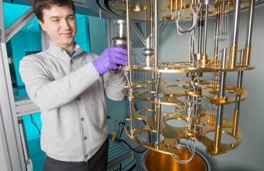 Alex Romanenko prepares to supercool superconducting accelerator cavities, the silver-colored objects, to convert it into a quantum device. Photo: Reidar Hahn