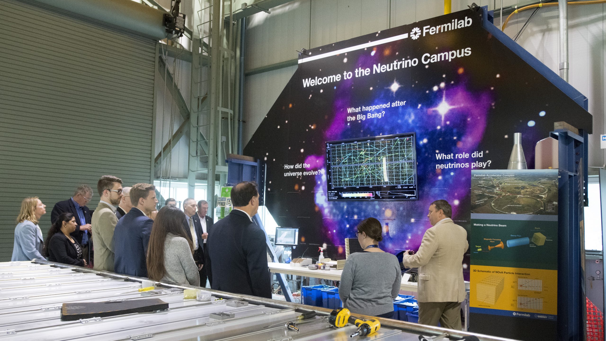 Before taking the visitors on an underground tour, scientists Peter Shanahan and Louise Suter (right) brief members and staff of the House Science Committee about Fermilab’s neutrino program. Photo: Reidar Hahn
