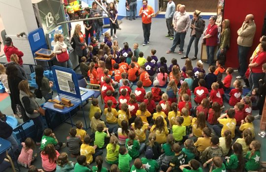 A volunteer prepares a large school field trip for a day of STEM activities. Photo: SciTech Museum