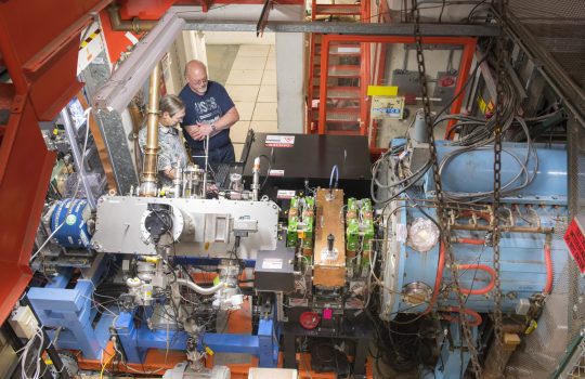 David Johnson, left, and Todd Johnson work on the recently installed laser notcher in the Fermilab accelerator complex. The laser notcher, the first application of its kind in an in-production particle accelerator, has helped boost particle beam production. Photo: Reidar Hahn