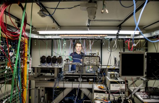 Artur Apresyan works on electronics and instrumentation in a beamline at Fermilab for the Large Hadron Collider's CMS detector. Photo: Reidar Hahn