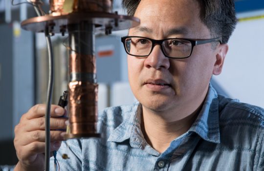 Aaron Chou works on an experiment that uses qubits to look for direct evidence of dark matter. Photo: Reidar Hahn