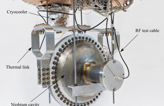 A superconducting radio-frequency accelerator cavity is mounted and connected to a cryocooler, cooling the cavity without the use of liquid helium. This new device could make it easier to produce high-average-power electron beams for industrial applications. Photo: Marty Murphy