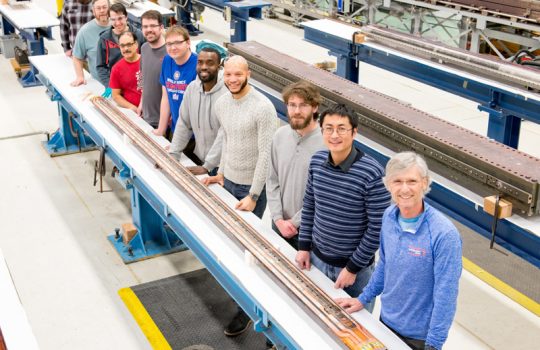 Fermilab engineers and technicians stand by a magnet coil made for the High-Luminosity LHC. Photo: Reidar Hahn