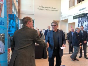 Fermilab's Tom Kroc, left, welcomes U.S. Energy Secretary Rick Perry to the Fermilab booth. Photo: Aaron Sauers