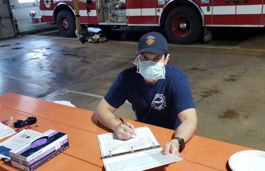 Lieutenant Steve Hernandez of the Fermilab Fire Department reviews information passed to him from previous shifts. Photo: Chuck Kuhn