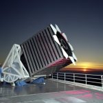 A large telescope on a rooftop, the sunset behind it