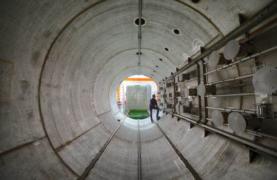 Worker stands in large cylinder