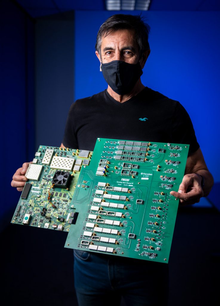 Masked man holding an electronics panel