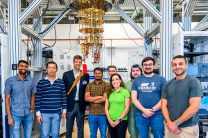 Photo taken at SQMS Quantum Garage at Fermilab. Pictured L-R: Akshay Murthy, associate scientist at Fermilab; Yao Lu, associate scientist at Fermilab; Jason Orcutt, principal research scientist at IBM; Tanay Roy, associate scientist at Fermilab; Andre Vallieres, PhD student at Northwestern University; Silvia Zorzetti, department head, quantum computing co-design and communication at Fermilab; Jacob Hanson-Flores, summer intern at Fermilab; Alessandro Reineri, PhD student at Illinois Institute of Technology; Joey Yaker, PhD student at Northwestern University. (Credit: Dan Svoboda, Fermilab)