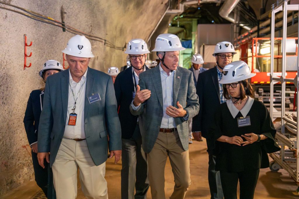 Secretary of Energy Chris Wright (center) speaks with Interim Director of Fermilab Young-Kee Kim (right) as Project Director of LBNF-DUNE-US Jim Kerby (second from left) and President of University of Chicago Paul Alivisatos (third from left) walk with them during an underground tour of DUNE prototype detectors and quantum and dark matter labs on July 17, 2025. Credit: Ryan Postel, Fermilab