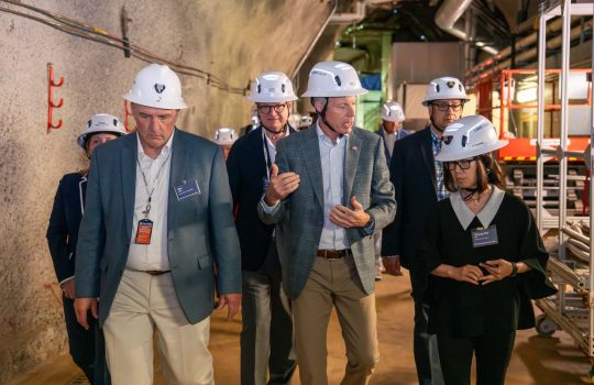 Secretary of Energy Chris Wright (center) speaks with Interim Director of Fermilab Young-Kee Kim (right) as Project Director of LBNF-DUNE-US Jim Kerby (second from left) and President of University of Chicago Paul Alivisatos (third from left) walk with them during an underground tour of DUNE prototype detectors and quantum and dark matter labs on July 17, 2025. Credit: Ryan Postel, Fermilab