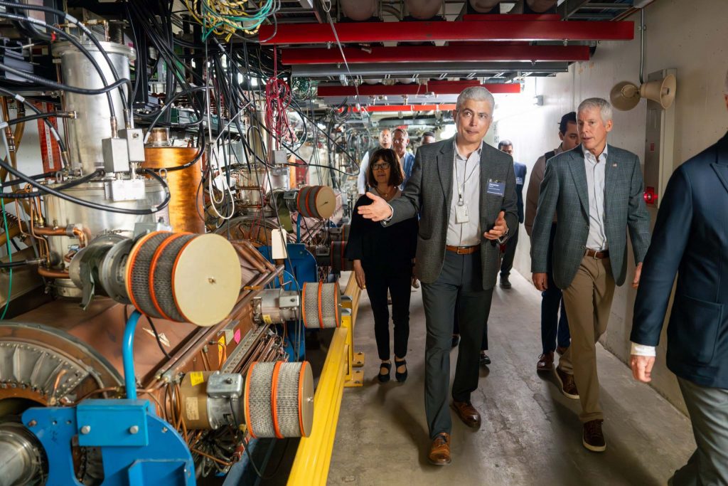 Head of Fermilab Accelerator Directorate Alexander Valishev (center) shows Secretary of Energy Chris Wright (right) part of the Main Injector, which produces the world’s most powerful high-energy neutrino beam, on July 17, 2005. Credit: Ryan Postel, Fermilab