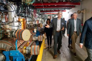 Head of Fermilab Accelerator Directorate Alexander Valishev (center) shows Secretary of Energy Chris Wright (right) part of the Main Injector, which produces the world’s most powerful high-energy neutrino beam, on July 17, 2005. Credit: Ryan Postel, Fermilab