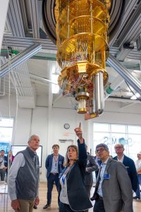 Director of the Superconducting Quantum Materials and Systems Center Anna Grassellino (center) points to superconducting quantum computing processor during a tour of SQMS for Secretary of Energy Chris Wright (left) on July 17, 2025. Credit: Ryan Postel, Fermilab