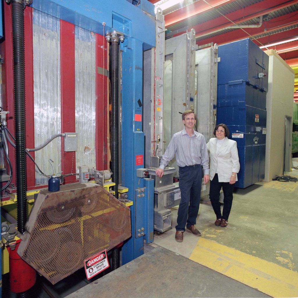 Byron Lundberg and Regina Rameika in front of the DONUT detector. Credit Reidar Hahn, Fermilab