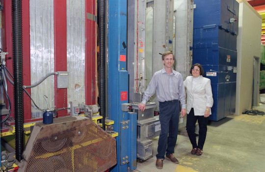 Byron Lundberg and Regina Rameika in front of the DONUT detector. Credit Reidar Hahn, Fermilab