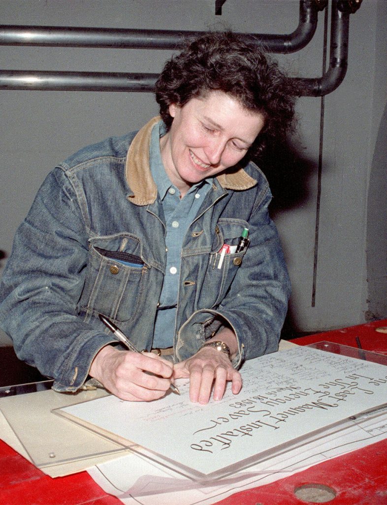 Helen Edwards signs her name to a ceremonial document marking the installation of the final superconducting magnet in the Tevatron on March 18, 1983. Credit: Fermilab