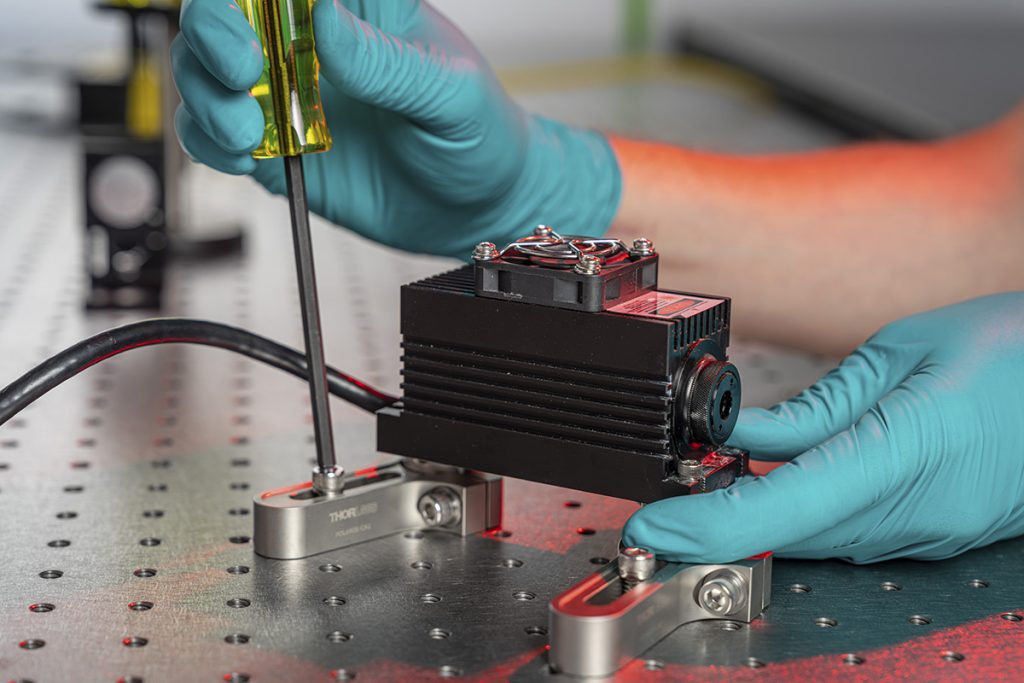 Dylan Temples works with a laser inside the MAGIS-1000 research space at Fermilab. Credit: JJ Starr, Fermilab