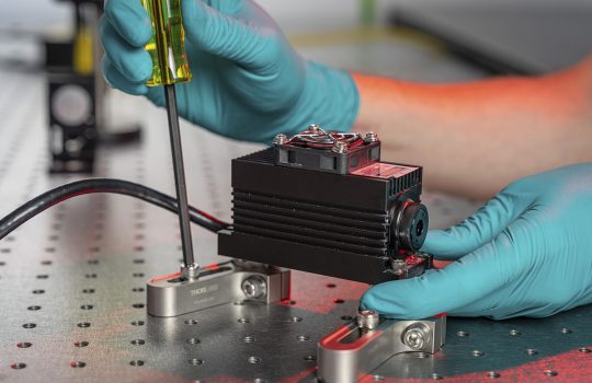 Dylan Temples works with a laser inside the MAGIS-100 research space at Fermilab. Credit: JJ Starr, Fermilab