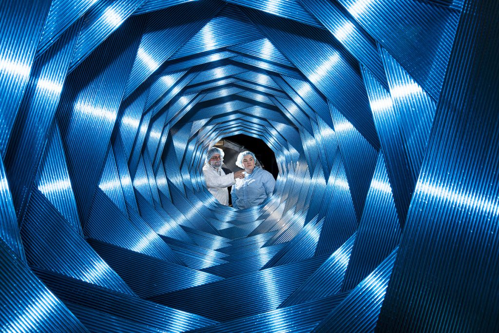 The Mu2e tracker uses straw tubes filled with gas to detect the momentum of an electron. Eighteen panels, each with 96 straw tubes, are aligned to create an almost circular opening for unwanted particles to pass through. Credit: Ryan Postel, Fermilab
