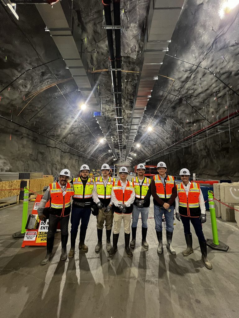 A team from Brazil visits the central utility space, nearly a mile underground at the Sanford Underground Research Facility. Credit: Roza Doubnik