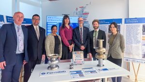 Group photo of participants at the UK showcase event, featuring 7 participants standing together in front of a table in a collaborative setting.
