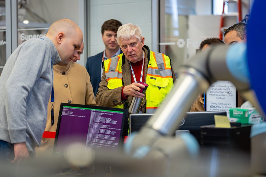 Fermilab Director Norbert Holtkamp talks with employees inside ICB — the Industrial Center Building — on the Fermilab campus. Credit: JJ Starr, Fermilab
