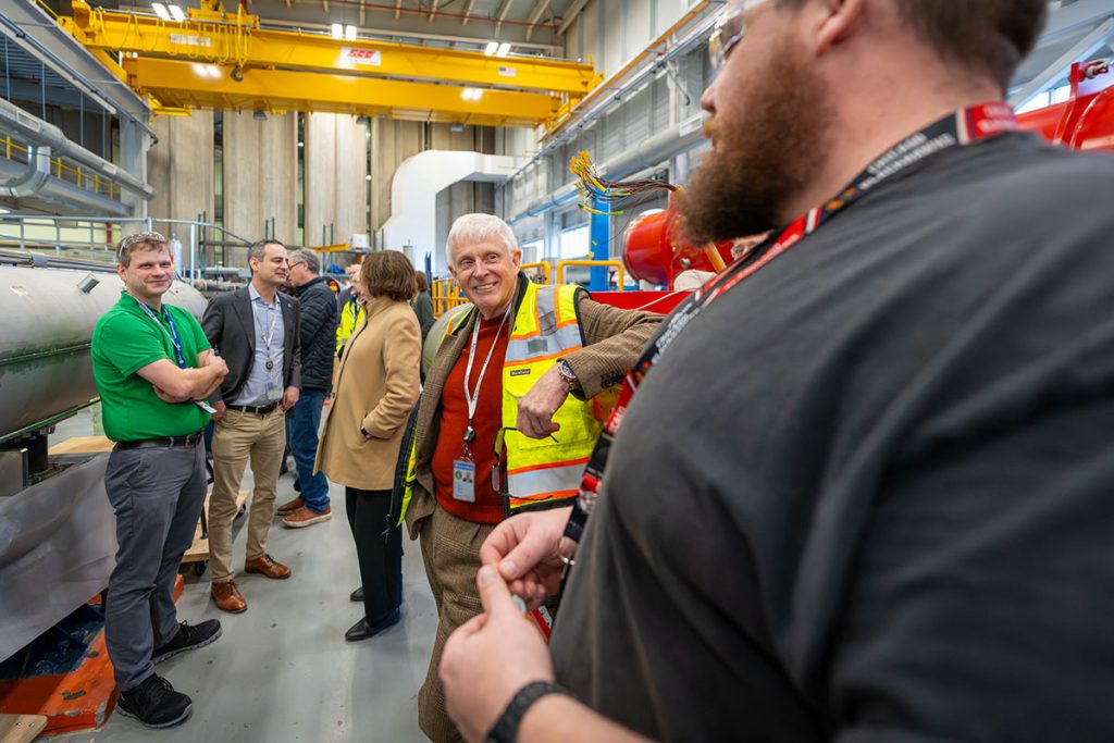 Fermilab Director Norbert Holtkamp talks with employees inside ICB — the Industrial Center Building — on the Fermilab campus. Credit: JJ Starr, Fermilab